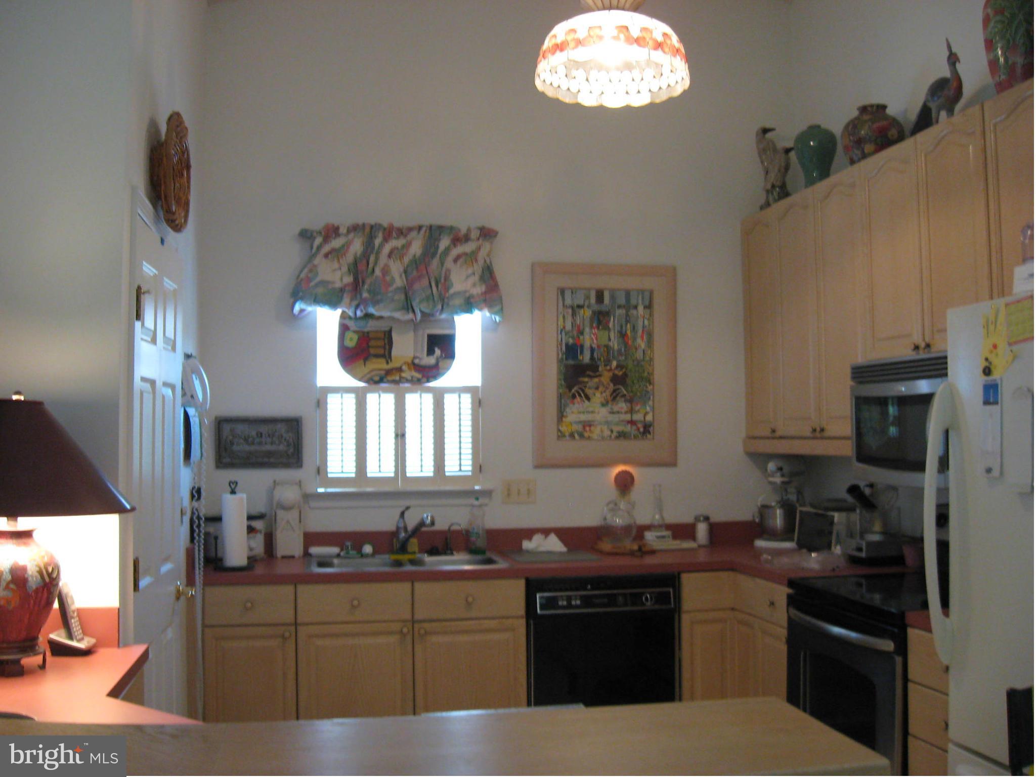 1236 Back Creek Loop, Unit 1236 Solomons, MD 20688 - Photo 2 of 24 a kitchen with stainless steel appliances a sink stove and refrigerator