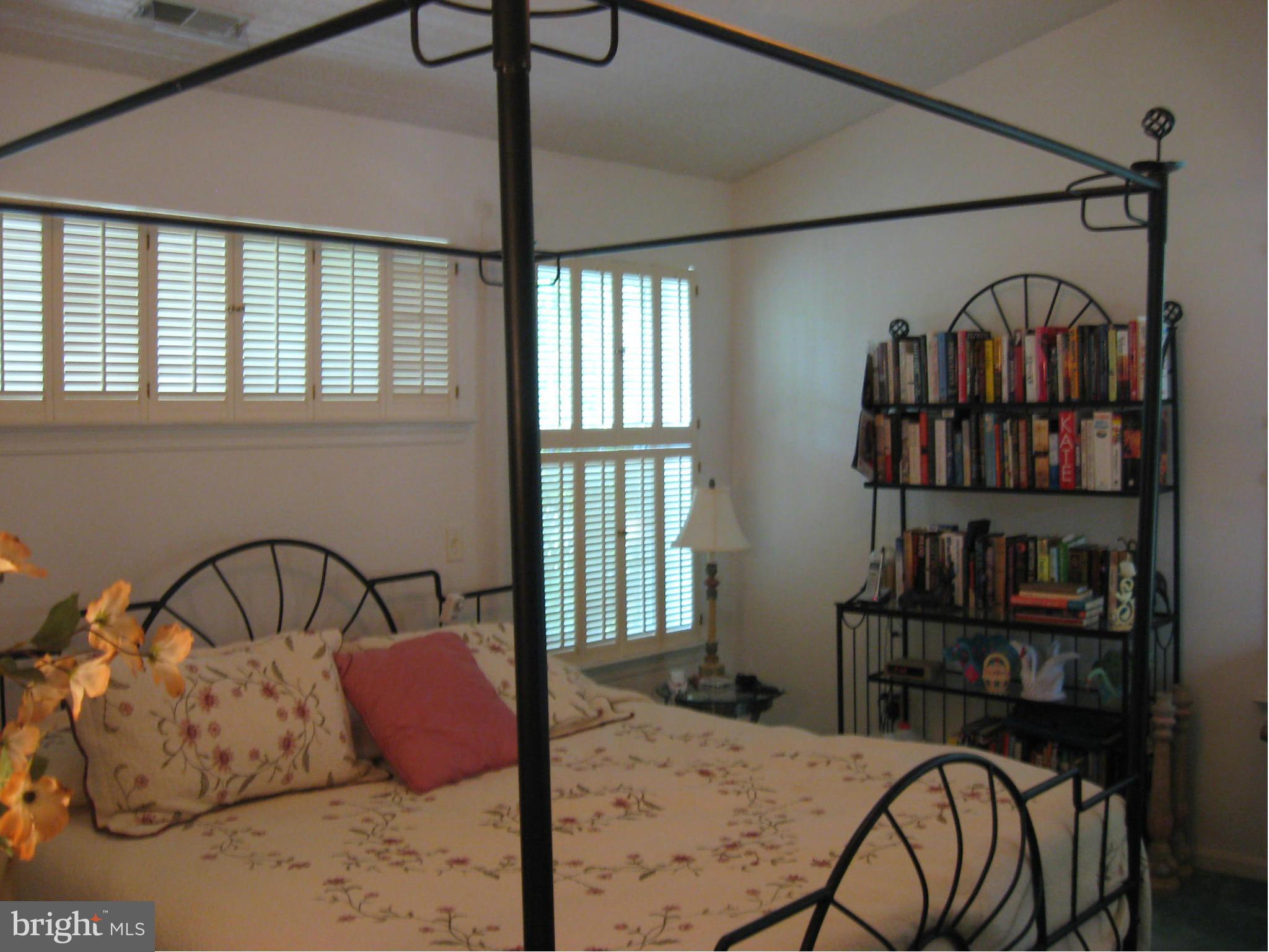 1236 Back Creek Loop, Unit 1236 Solomons, MD 20688 - Photo 12 of 24 a bedroom with furniture and a window