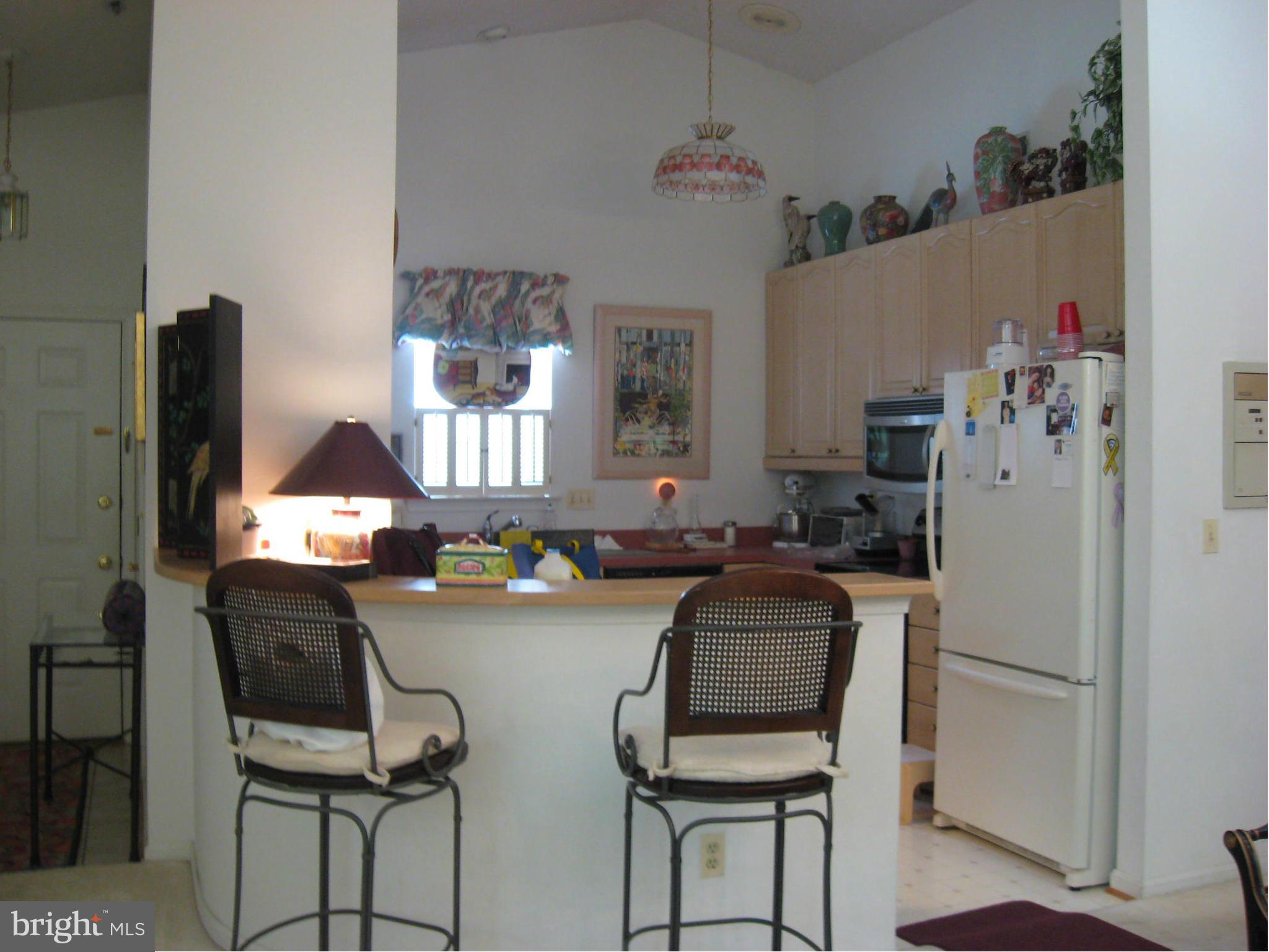 1236 Back Creek Loop, Unit 1236 Solomons, MD 20688 - Photo 3 of 24 a dining room with furniture and window