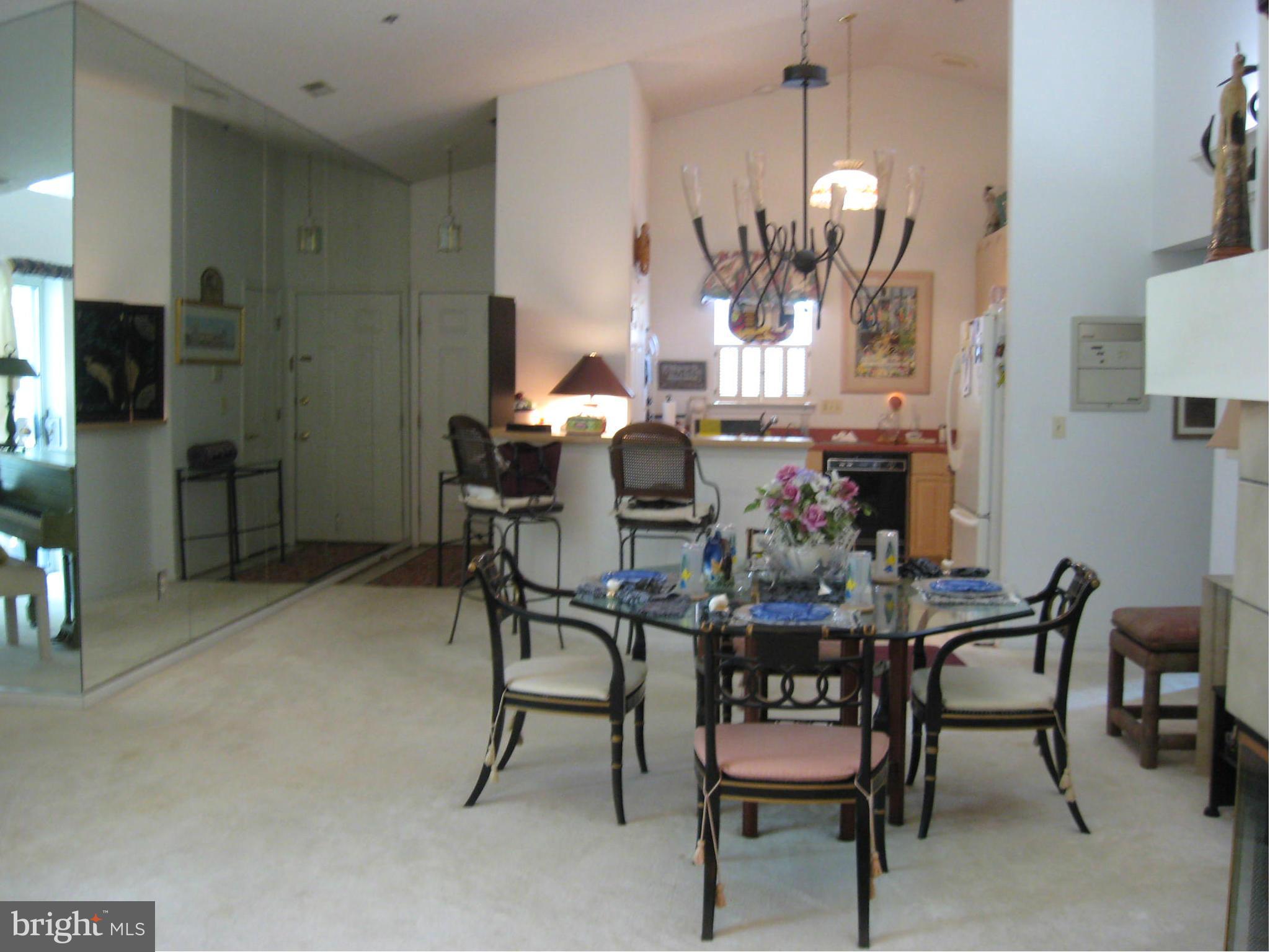 1236 Back Creek Loop, Unit 1236 Solomons, MD 20688 - Photo 5 of 24 a view of a dining room with furniture and chandelier