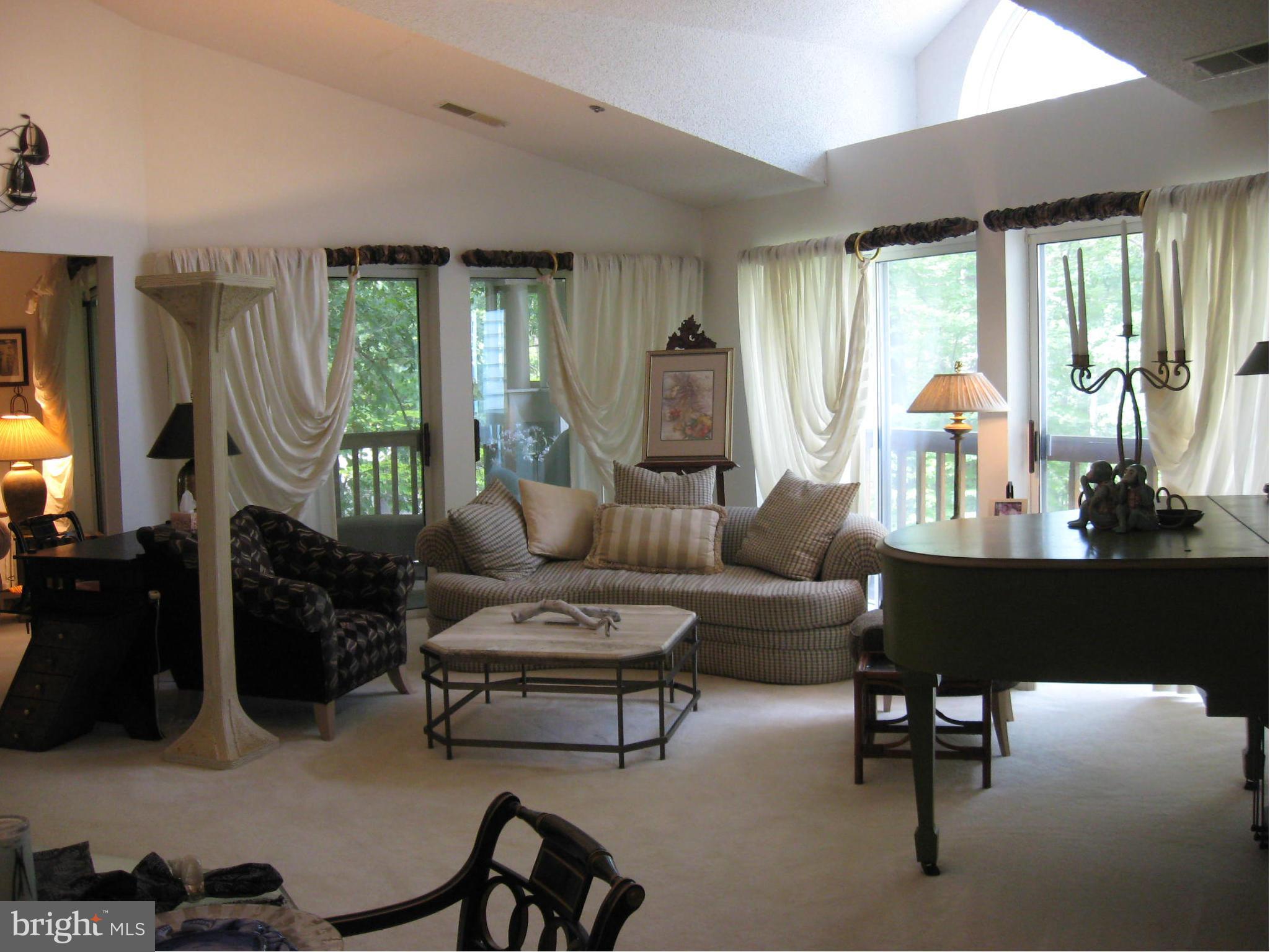 1236 Back Creek Loop, Unit 1236 Solomons, MD 20688 - Photo 6 of 24 a living room with furniture and a large window