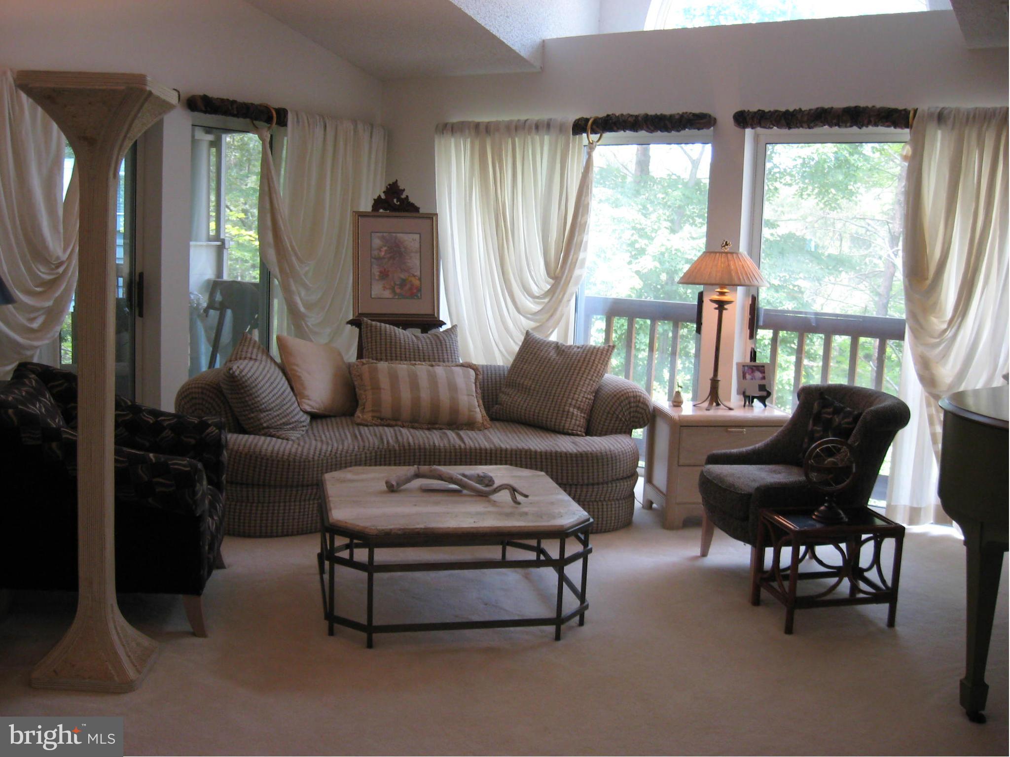 1236 Back Creek Loop, Unit 1236 Solomons, MD 20688 - Photo 7 of 24 a living room with furniture and a large window