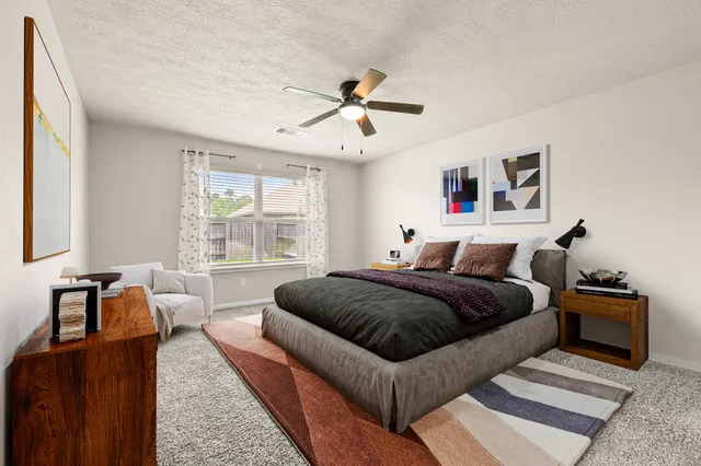 a living room with a bed furniture and a window