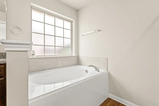a white bath tub sitting next to a window