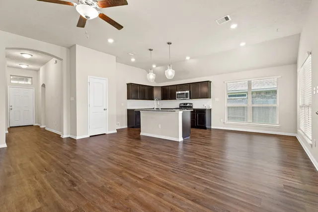 a view of a kitchen with a sink and microwave