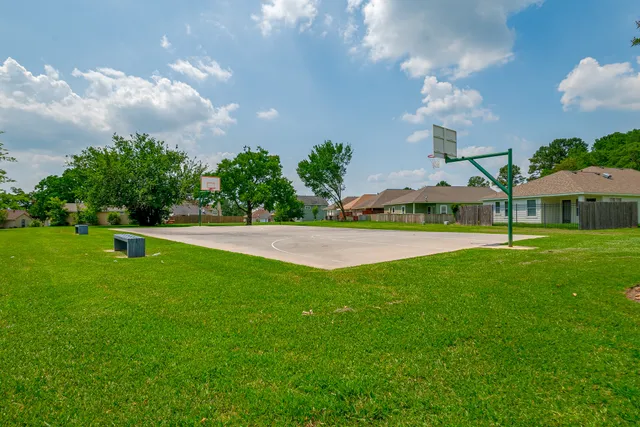 a view of yard with swimming pool and green space