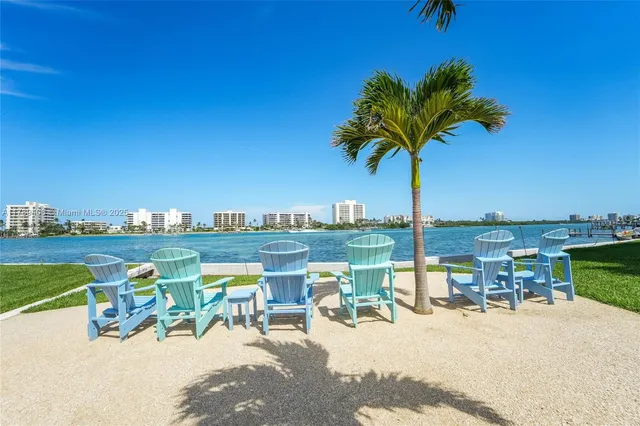 a view of a lake with a table and chairs