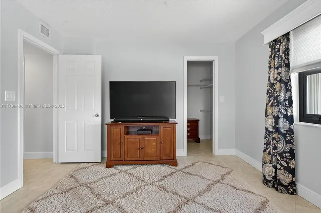 a living room with a flat screen tv and a couch