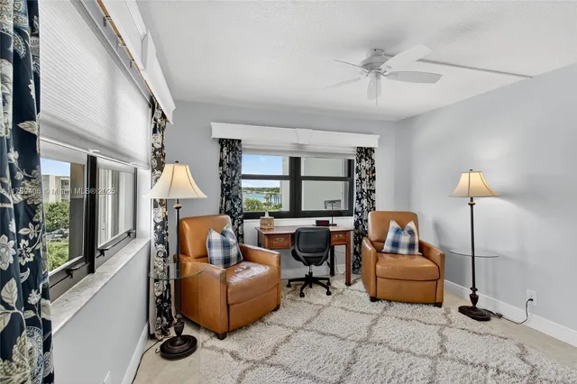 a living room with furniture and a floor to ceiling window