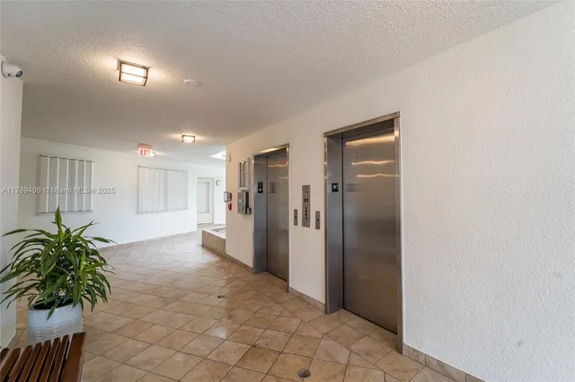 a view of a hallway with potted plants