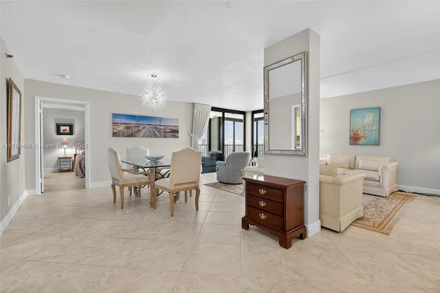 a living room with furniture and a dining table with wooden floor