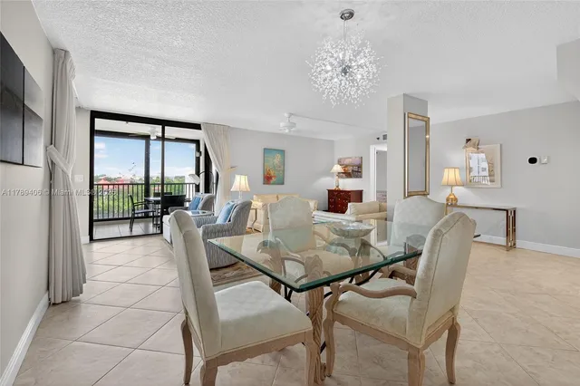 a view of a dining room with furniture and a chandelier
