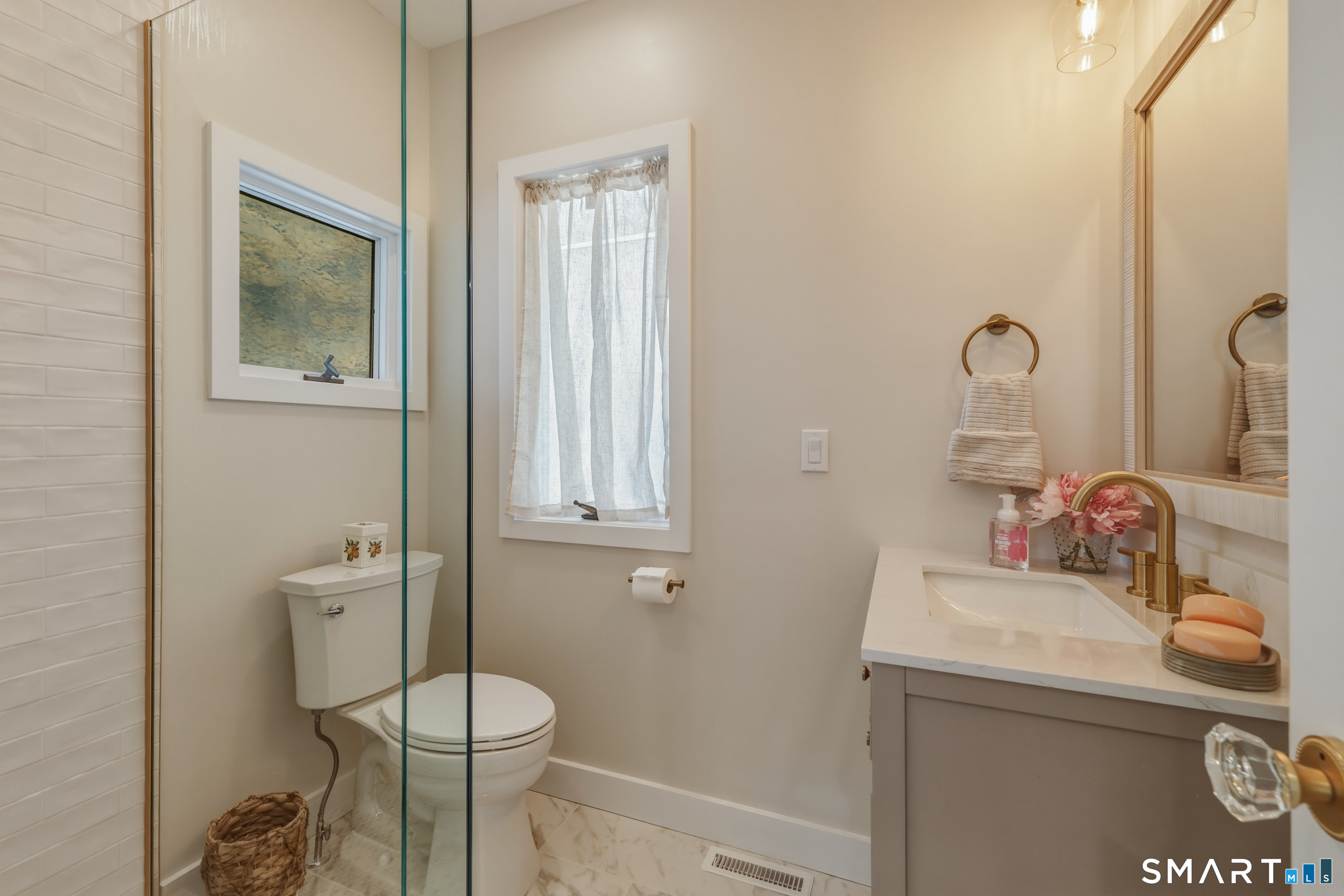 31 Sols Point Road Clinton, CT 06413 - Photo 12 of 40 Renovated full bath on main level with tile flooring, shower w/tile surround and glass enclosure.