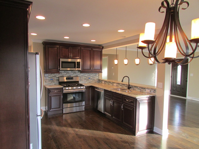 7719 East Prairie Road Skokie, IL 60076 - Photo 18 of 25 a kitchen with stainless steel appliances granite countertop a sink a stove and a refrigerator