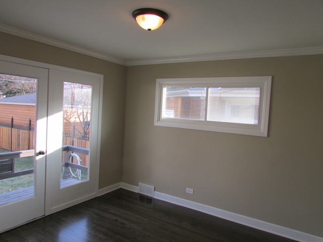 7719 East Prairie Road Skokie, IL 60076 - Photo 21 of 25 an empty room with wooden floor and windows