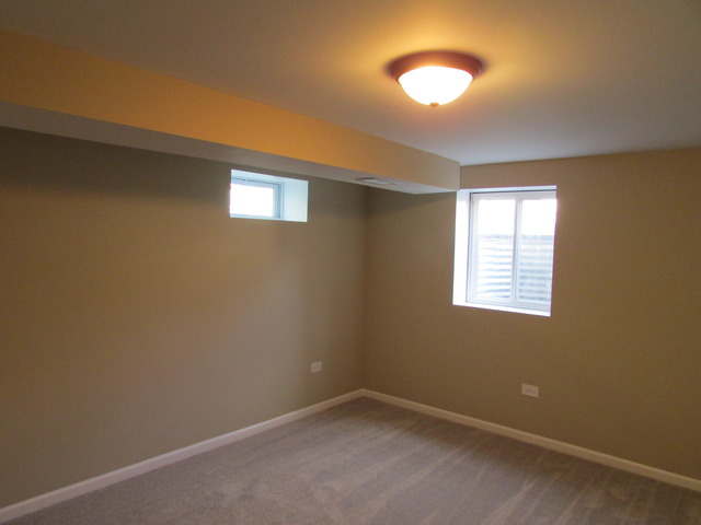 7719 East Prairie Road Skokie, IL 60076 - Photo 23 of 25 an empty room with a ceiling fan and window