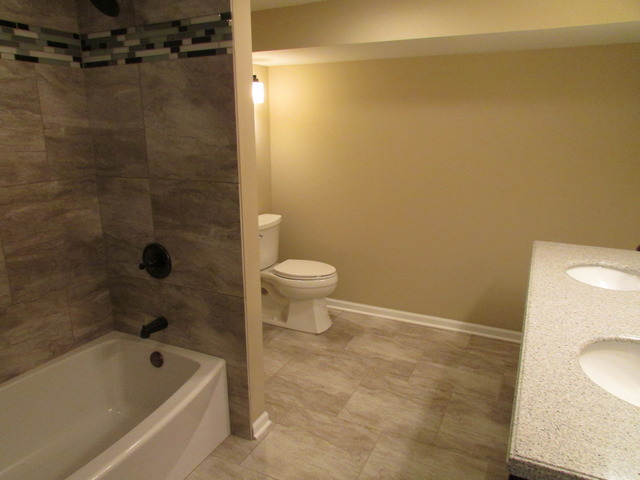 7719 East Prairie Road Skokie, IL 60076 - Photo 7 of 25 a bathroom with a bathtub and a toilet