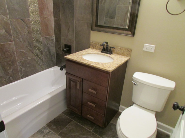7719 East Prairie Road Skokie, IL 60076 - Photo 8 of 25 a bathroom with a toilet sink and mirror