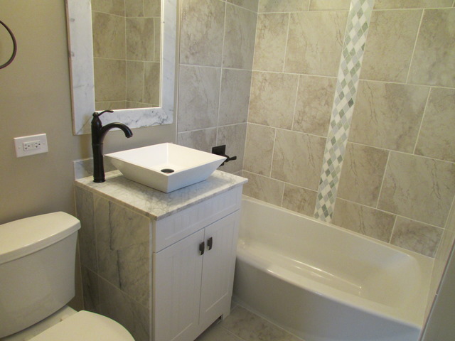 7719 East Prairie Road Skokie, IL 60076 - Photo 9 of 25 a bathroom with a sink toilet and shower