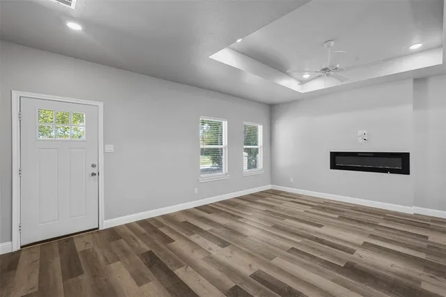a view of empty room with window and ceiling fan