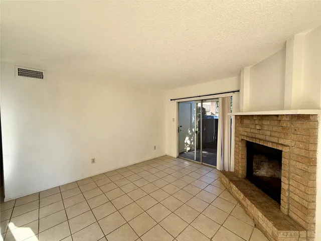 a view of an empty room with a fireplace