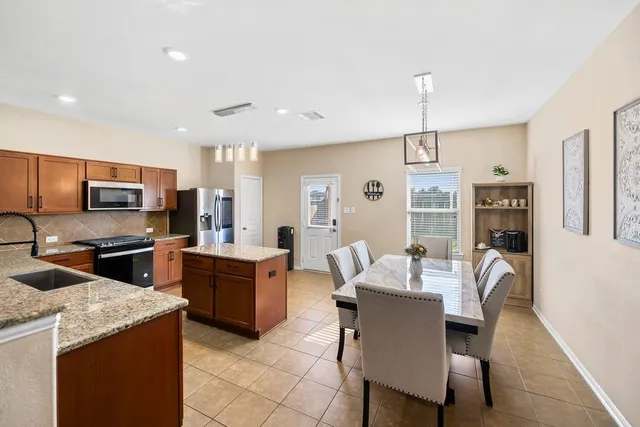 a large kitchen with a table and chairs in it