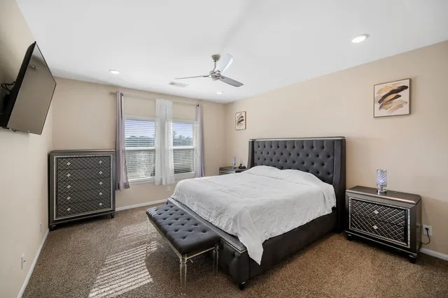 a bedroom with a bed and a tv