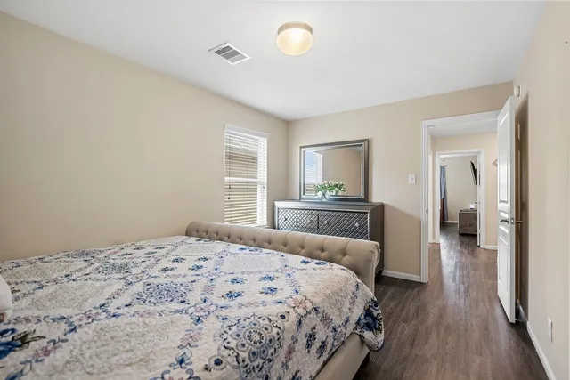 a bedroom with a bed and a dresser