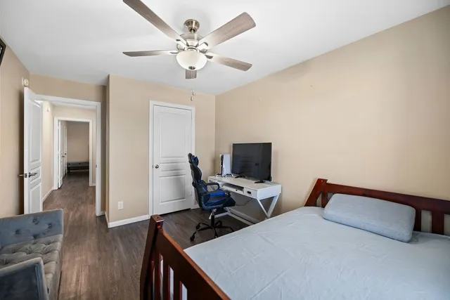 a bedroom with a bed and wooden floor