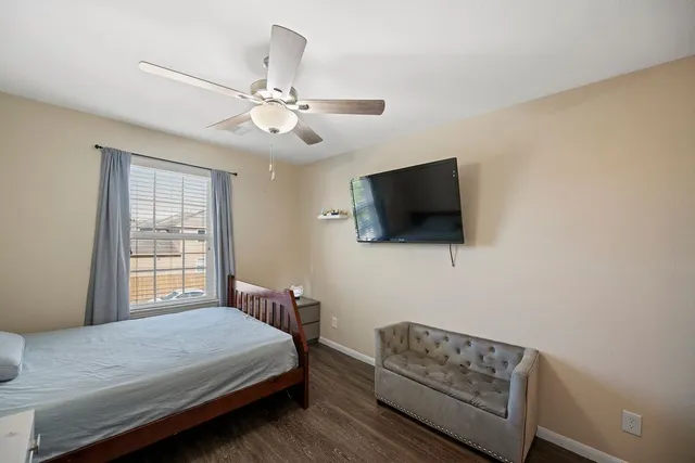 a bedroom with a bed and a flat screen tv