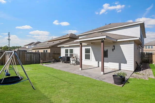 a view of a house with backyard and a slide