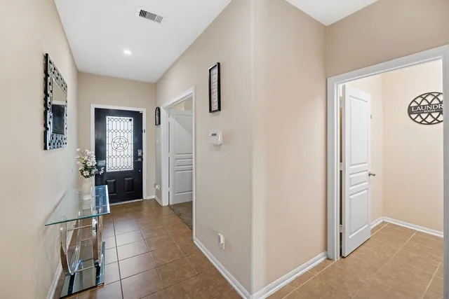 a view of a hallway with closet and front door