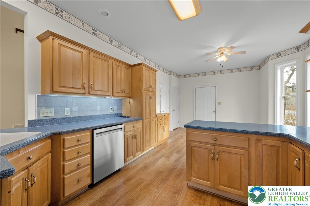1 Pinewood Circle Hazleton, PA 18202 - Photo 11 of 33 a kitchen with stainless steel appliances granite countertop a stove a sink dishwasher and cabinets with wooden floor