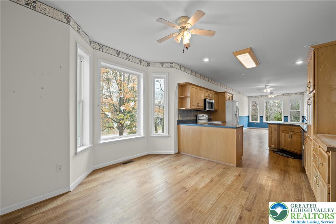 1 Pinewood Circle Hazleton, PA 18202 - Photo 14 of 33 a view of a kitchen with furniture a window and wooden floor