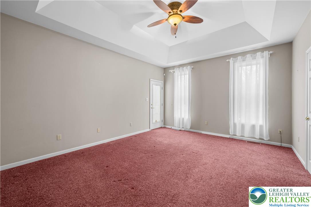 1 Pinewood Circle Hazleton, PA 18202 - Photo 17 of 33 an empty room with a chandelier fan and windows