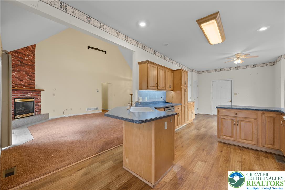 1 Pinewood Circle Hazleton, PA 18202 - Photo 10 of 33 a kitchen with granite countertop a stove cabinets and wooden floor