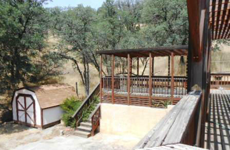18870 Reeds Creek Road Red Bluff, CA 96080 - Photo 4 of 10 a view of a balcony with floor to ceiling windows and wooden fence