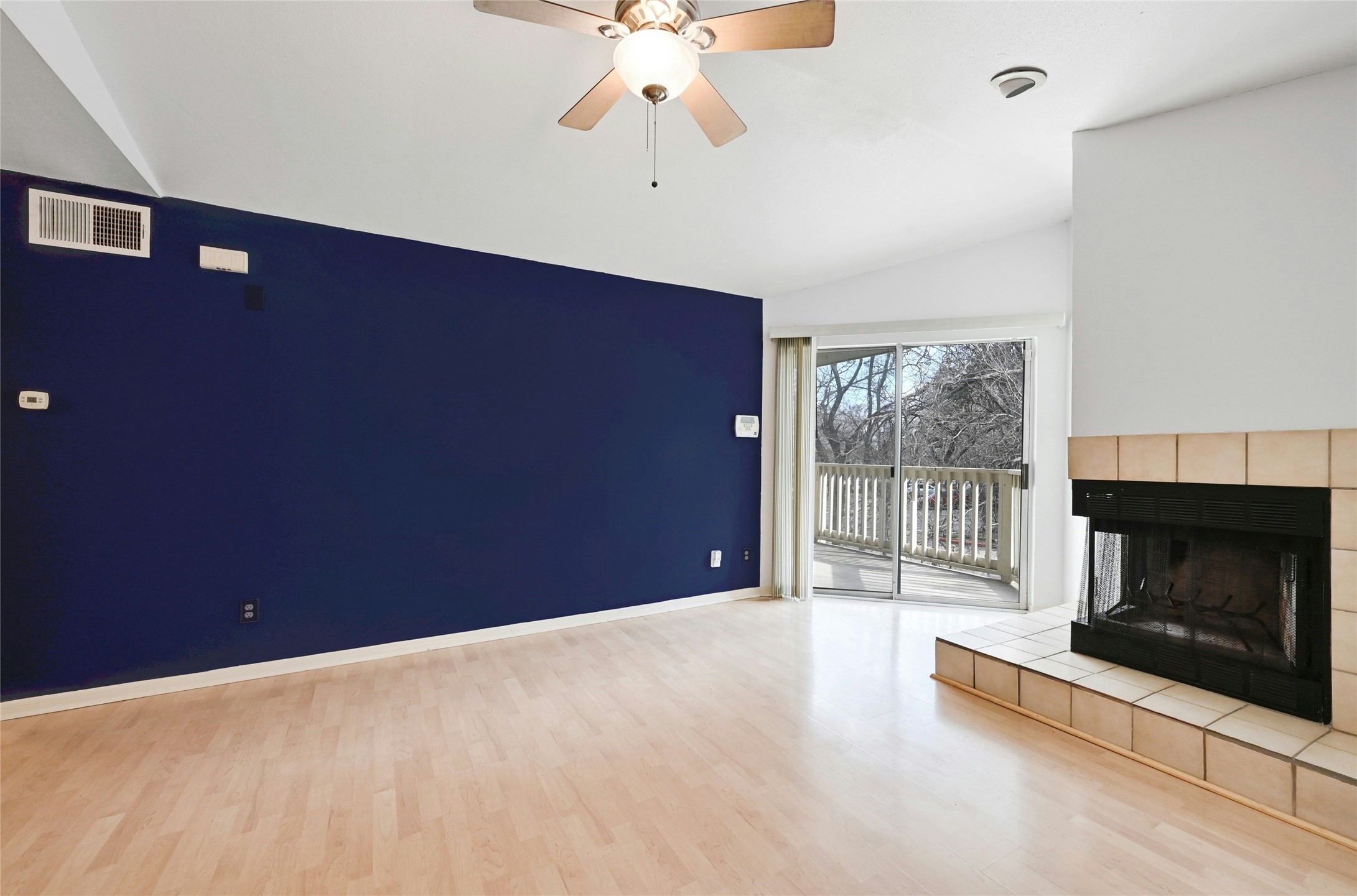 2450 Wickersham Lane, Unit 710 Austin, TX 78741 - Photo 5 of 20 a view of an empty room with a fireplace and a window