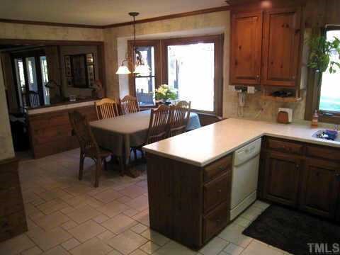 2841 Mattlyn Court Raleigh, NC 27613 - Photo 5 of 12 a kitchen with a sink cabinets and dining table