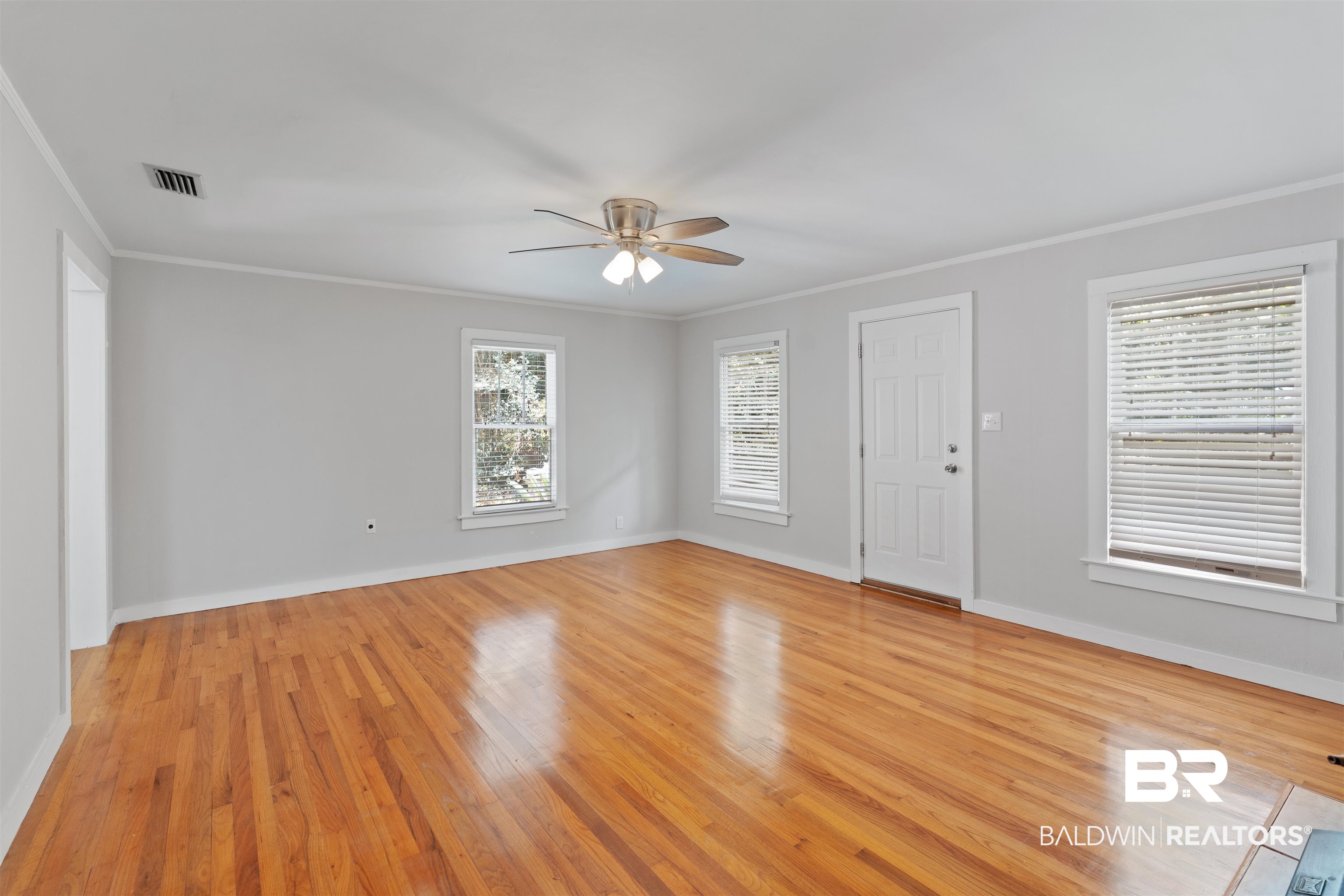 2126 Barron Place Mobile, AL 36605 - Photo 9 of 33 Unfurnished room featuring ceiling fan, crown molding, and light hardwood / wood-style floors
