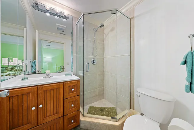 a bathroom with a granite countertop sink toilet mirror and shower