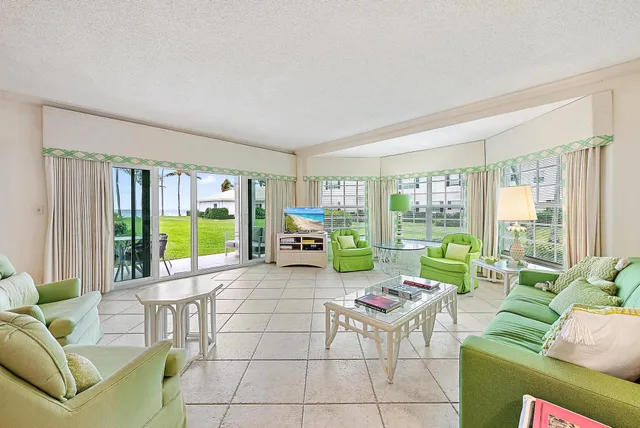 a living room with furniture and a floor to ceiling window