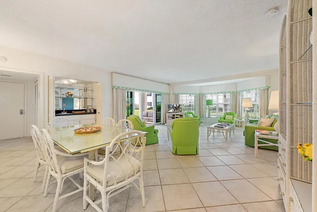 a dining room with furniture and a floor to ceiling window