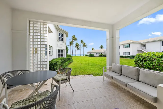 a living room with furniture and garden view