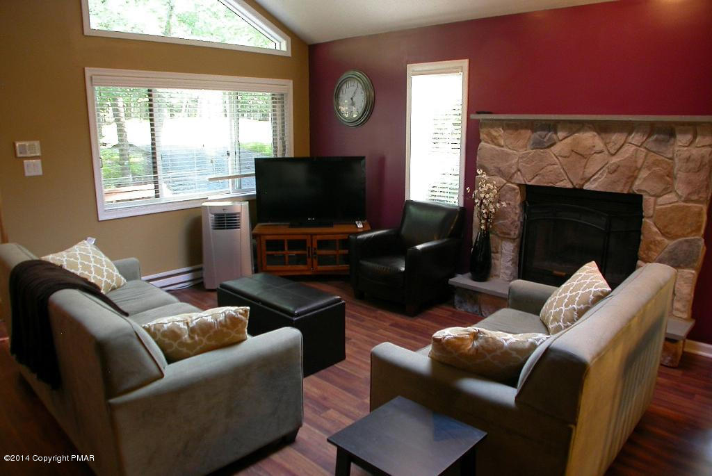 349 Canterbury Road Bushkill, PA 18324 - Photo 3 of 21 a living room with furniture a flat screen tv and a fireplace