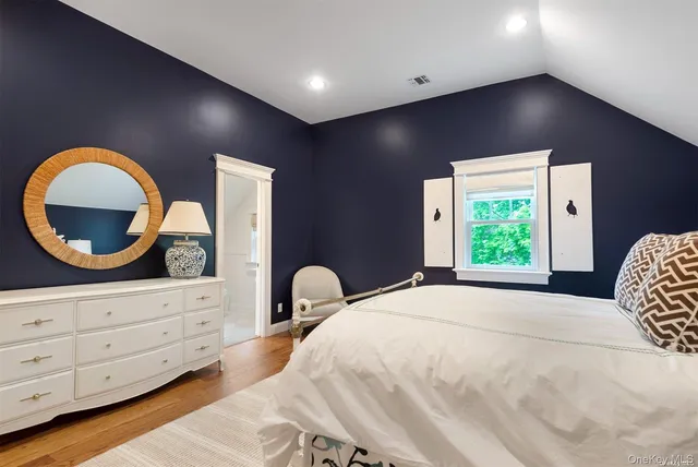 a bedroom with a large bed and a dresser