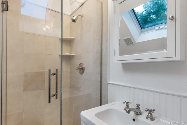 a bathroom with a sink and mirror
