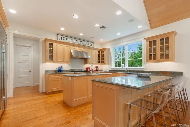 a kitchen with granite countertop a sink and a stove top oven