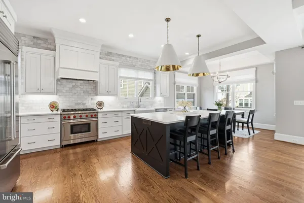 a front view of a house with a yard and potted plants