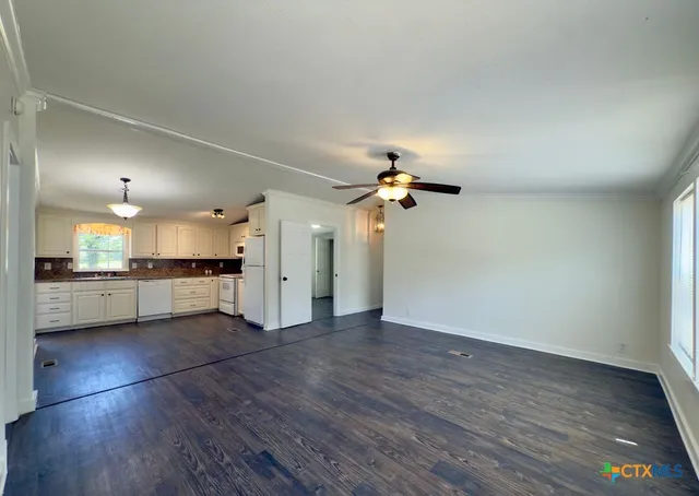 a view of a kitchen with a sink and a window